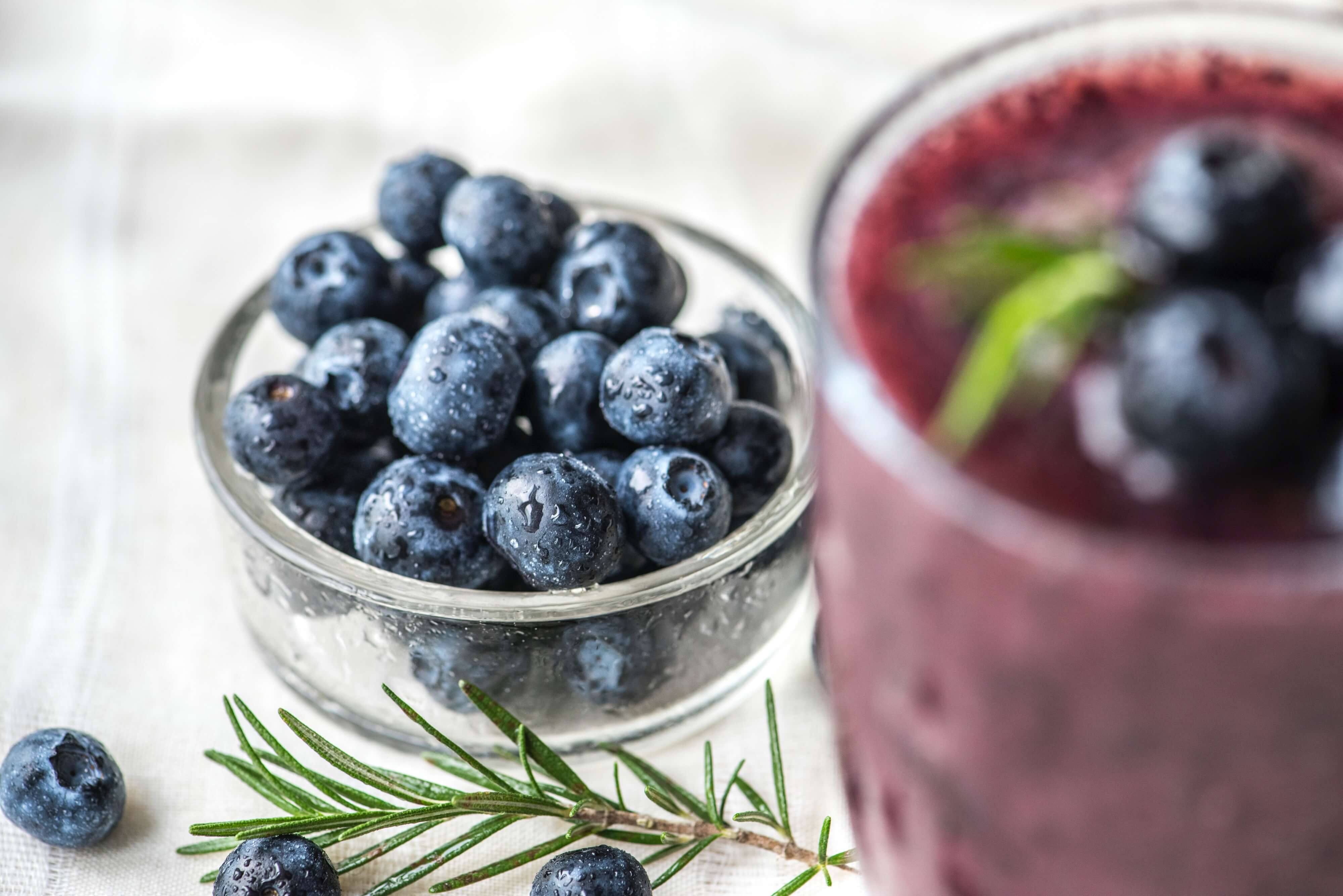 bowl of blueberries and smoothie - Hawley Orthodontics