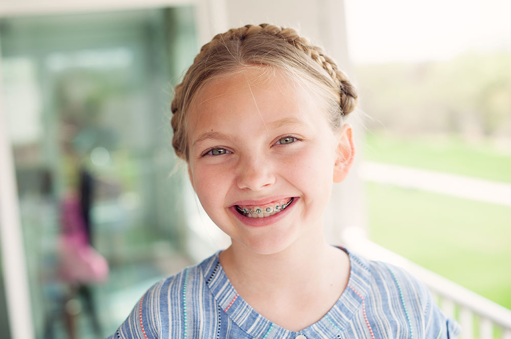 smiling young girl with phase 1 braces