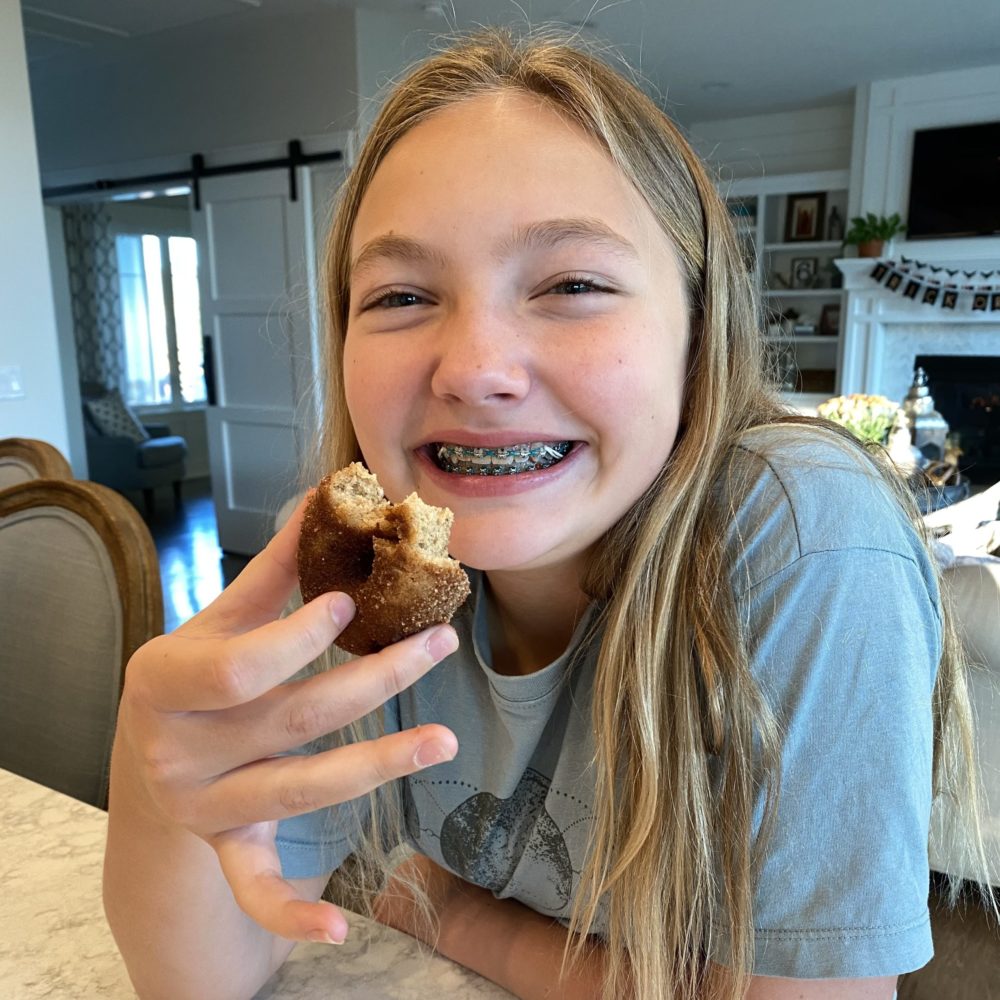 Girl with braces eating donut